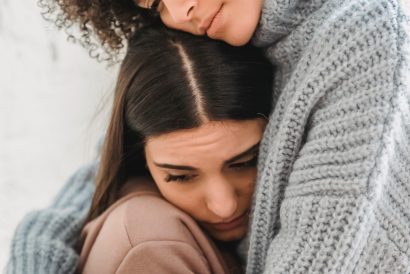 two ladies hugging for support